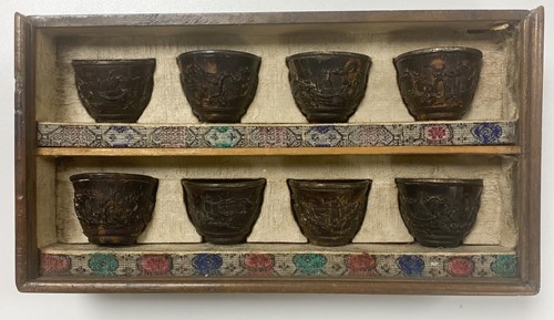 Lot 53 - A set of eight Chinese export carved and silver mounted coconut wood wine cups, Qing Dynasty, early 19th century