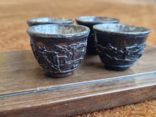 Lot 53 - A set of eight Chinese export carved and silver mounted coconut wood wine cups, Qing Dynasty, early 19th century