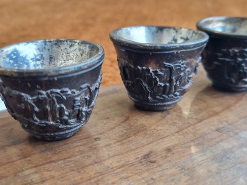 Lot 53 - A set of eight Chinese export carved and silver mounted coconut wood wine cups, Qing Dynasty, early 19th century