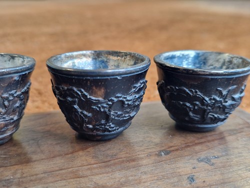 Lot 53 - A set of eight Chinese export carved and silver mounted coconut wood wine cups, Qing Dynasty, early 19th century