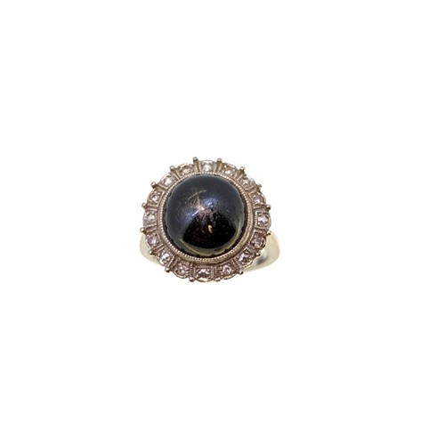 Lot 43 - A black star sapphire and diamond cluster ring