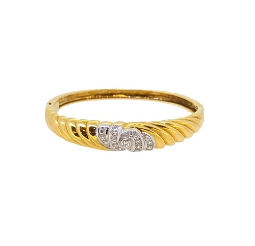 Lot 263 - An 18ct gold diamond set bangle