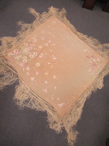 Lot 63 - A Chinese silk embroidered peach coloured shawl early 20th century