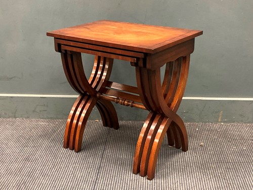 Lot 841 - A mahogany nest of three tables, on X-frame...