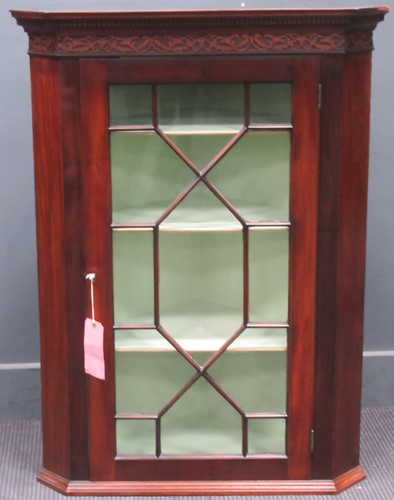 Lot 665 - An Edwardian mahogany corner cupboard with...