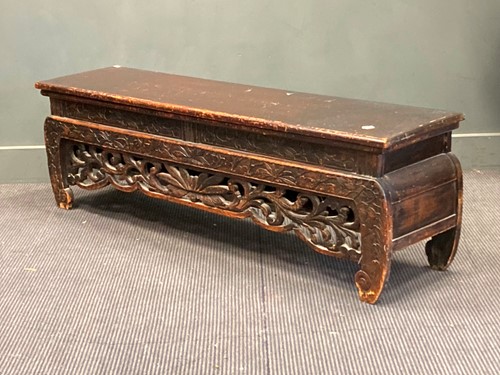 Lot 404 - A far eastern carved and ebonised bench seat...