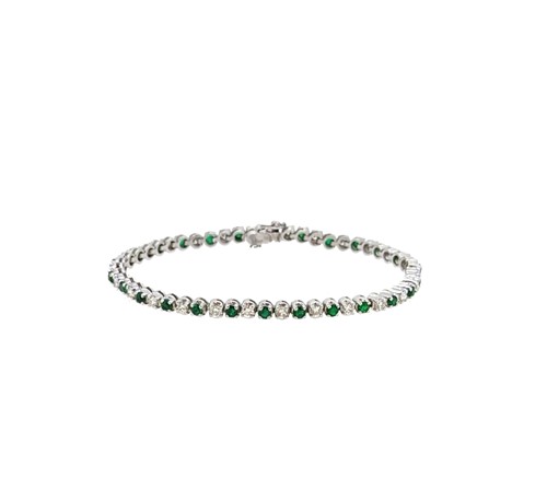 Lot 135 - An 18ct gold emerald and diamond line bracelet