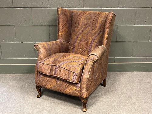 Lot 779 - A small wing back armchair on short cabriole...