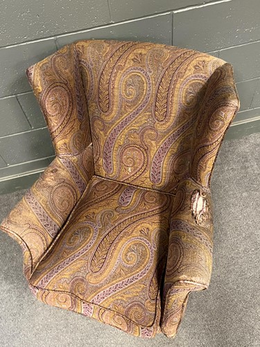Lot 779 - A small wing back armchair on short cabriole...