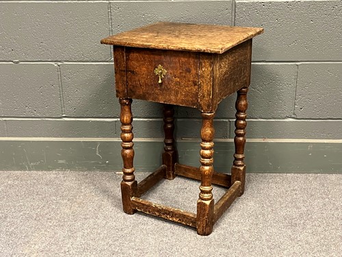 Lot 744 - An oak stool with single drawer on turned legs,...