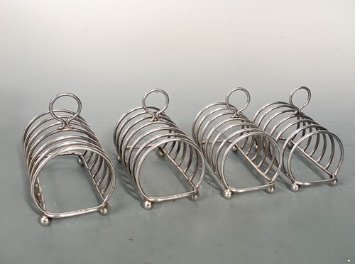 Lot 571 - A set of four Elizabeth II silver 6 bar toast racks