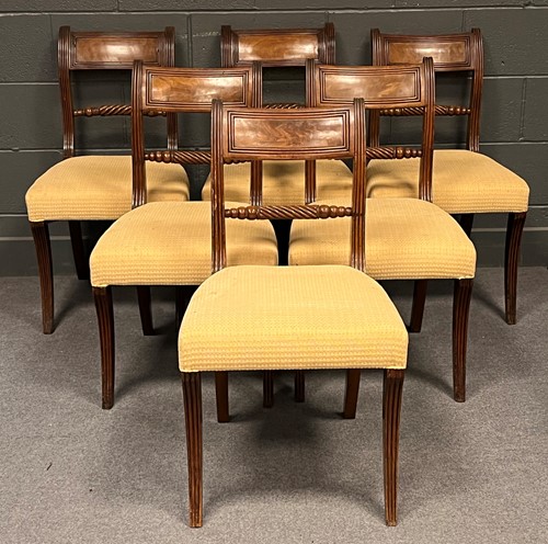 Lot 770 - A set of six Regency sabre leg chairs with...