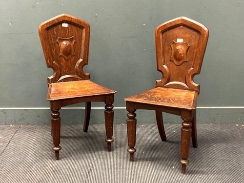 Lot 444 - A pair of Victorian oak hall chairs (2)