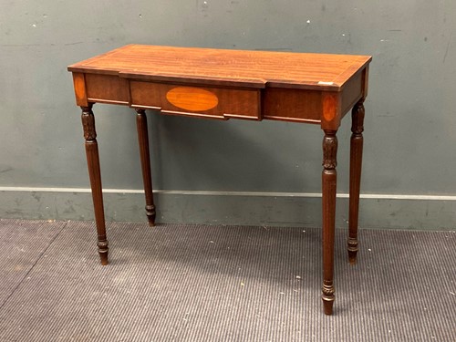 Lot 446 - A breakfront mahogany console table on fluted...
