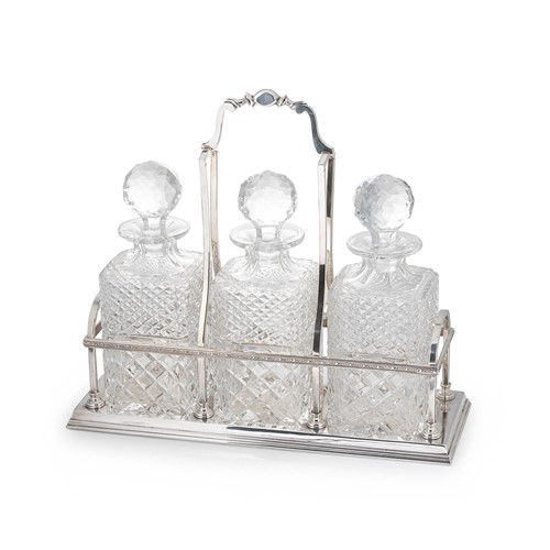 Lot 569 - An Elizabeth II silver three bottle decanter frame with associated cut glass decanters
