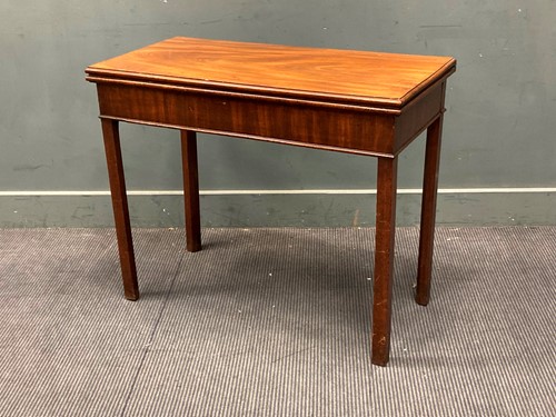 Lot 878 - A George III mahogany fold over card table...