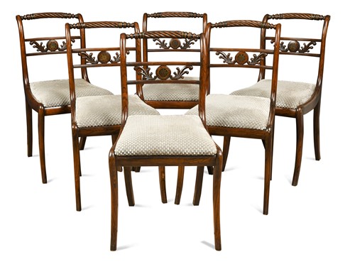 Lot 667 - A set of six Regency rosewood and brass inlaid dining chairs