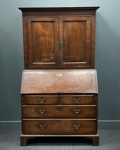 Lot 777 - A Georgian oak bureau bookcase, the moulded...