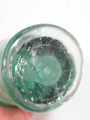 Lot 100 - A Victorian green glass dump paper weight with...