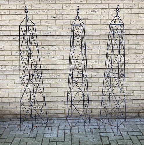Lot 939 - Three wirework garden obelisks, approx 178cm high