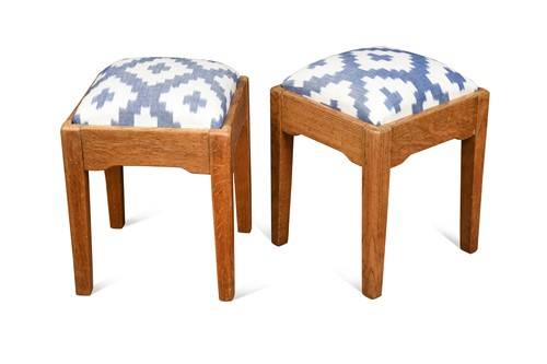 Lot 697 - A pair of Cotswold School pale oak footstools