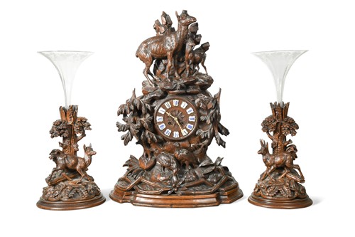 Lot 393 - A carved Black Forest clock garniture, 19th century