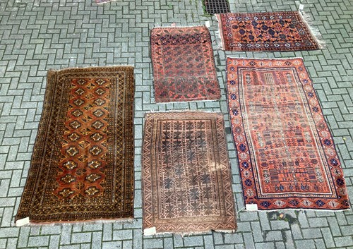 Lot 954 - Five Beluchi / Afgan rugs, 210 x 117cm, 149 x...