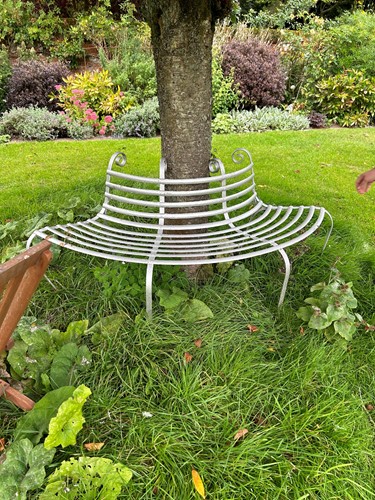 Lot 935 - A wrought metal silver painted tree bench on...