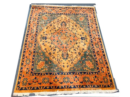 Lot 966 - A modern carpet in golden brown and blue with...