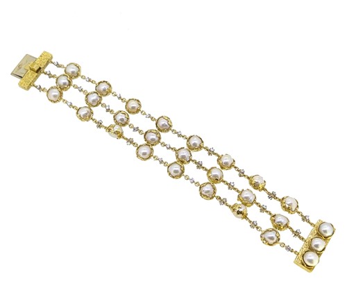 Lot 289 - Charles de Temple - A pearl and diamond 'Wrapped' bracelet, together with a matching single earring