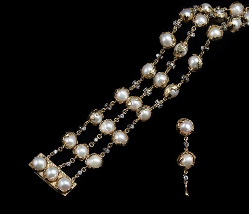 Lot 289 - Charles de Temple - A pearl and diamond 'Wrapped' bracelet, together with a matching single earring