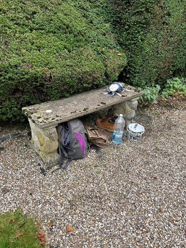 Lot 940 - A composite stone garden bench with...