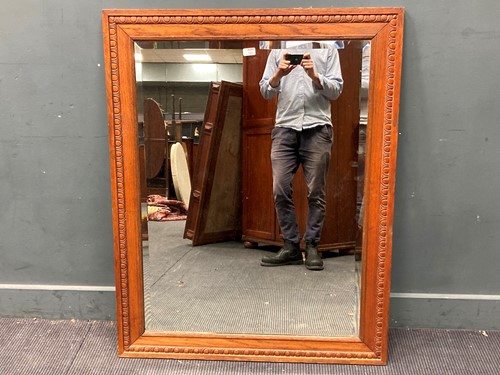 Lot 780 - An oak moulded frame mirror with bevelled...