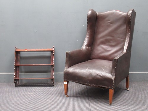 Lot 884 - An Edwardian wingback armchair upholstered in...