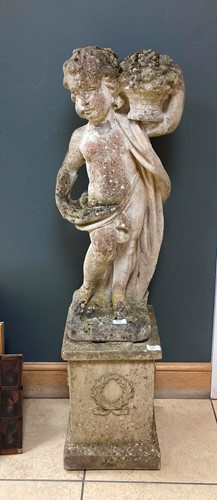 Lot 942 - A composite stone figure of a cherub holding...
