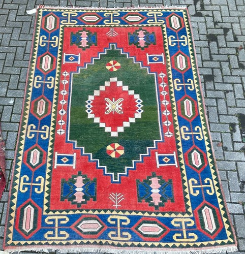 Lot 951 - A geometric tribal rug, with red ground and...