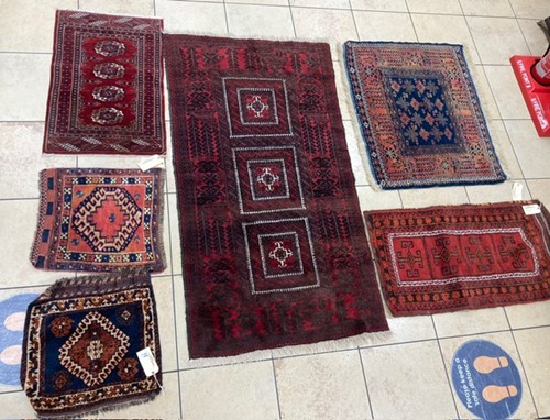 Lot 969 - A red ground Persian rug with three square...