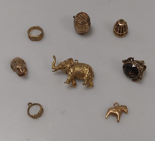 Lot 264 - A hallmarked 9ct gold elephant charm together...