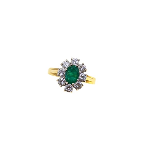 Lot 219 - An 18ct gold emerald and diamond cluster ring