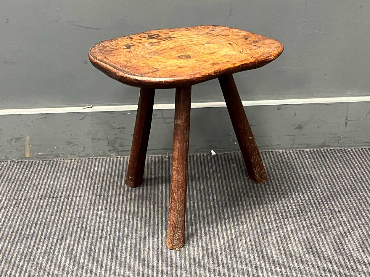Lot 843 - A small elm rustic table with three legs and a...