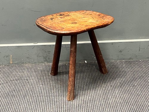 Lot 843 - A small elm rustic table with three legs and a...