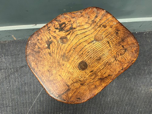 Lot 843 - A small elm rustic table with three legs and a...