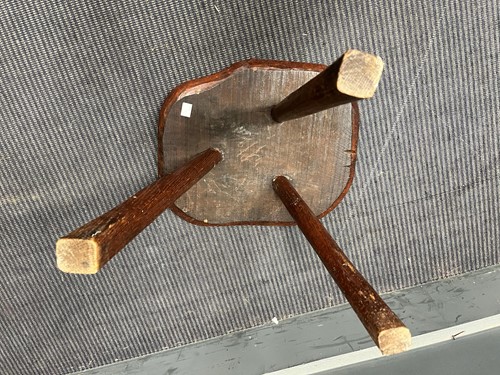 Lot 843 - A small elm rustic table with three legs and a...