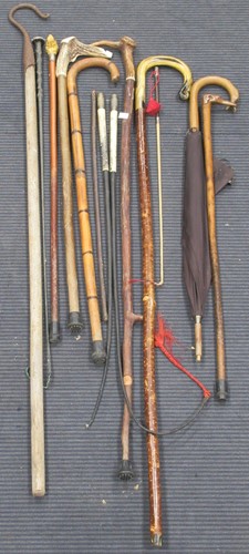 Lot 213 - A selection of walking sticks and umbrellas,...