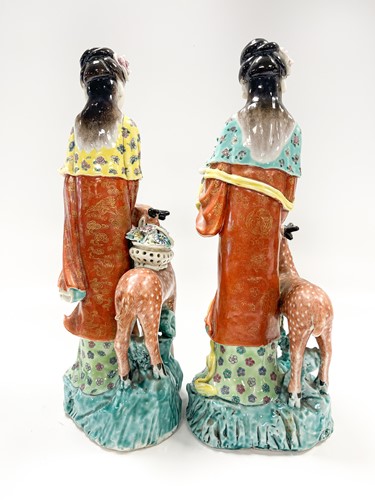 Lot 1 - Two similar Chinese enamelled porcelain figures of the Immortal Magu with deer, late Qing Dynasty