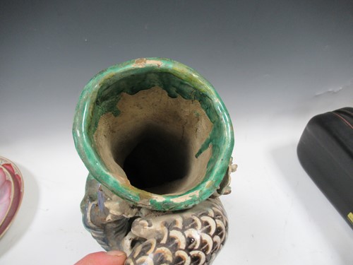 Lot 15 - An Oriental pottery vase decorated with a bird...