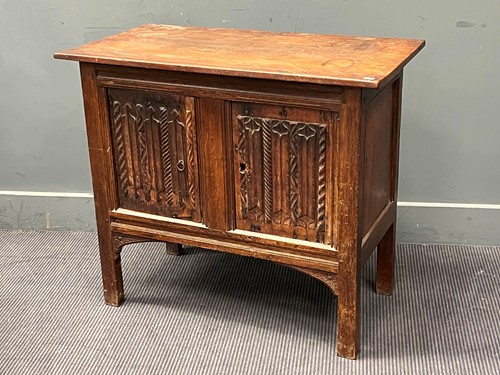 Lot 844 - An oak cabinet in the antique manner enclosed...