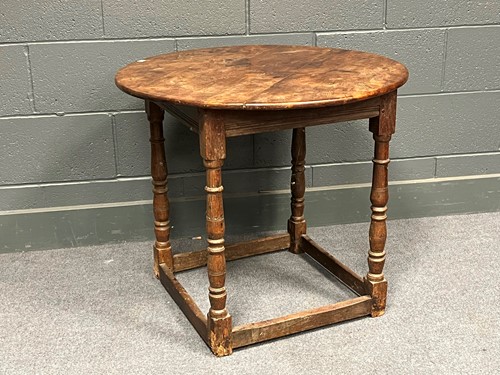 Lot 657 - A circular yewwood top table with associated...