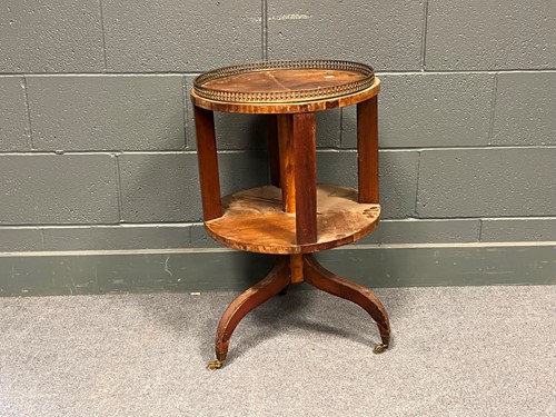 Lot 750 - A revolving bookcase with pierced brass...