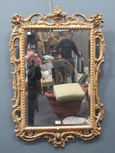 Lot 890 - A Victorian rococo style gilt framed wall...